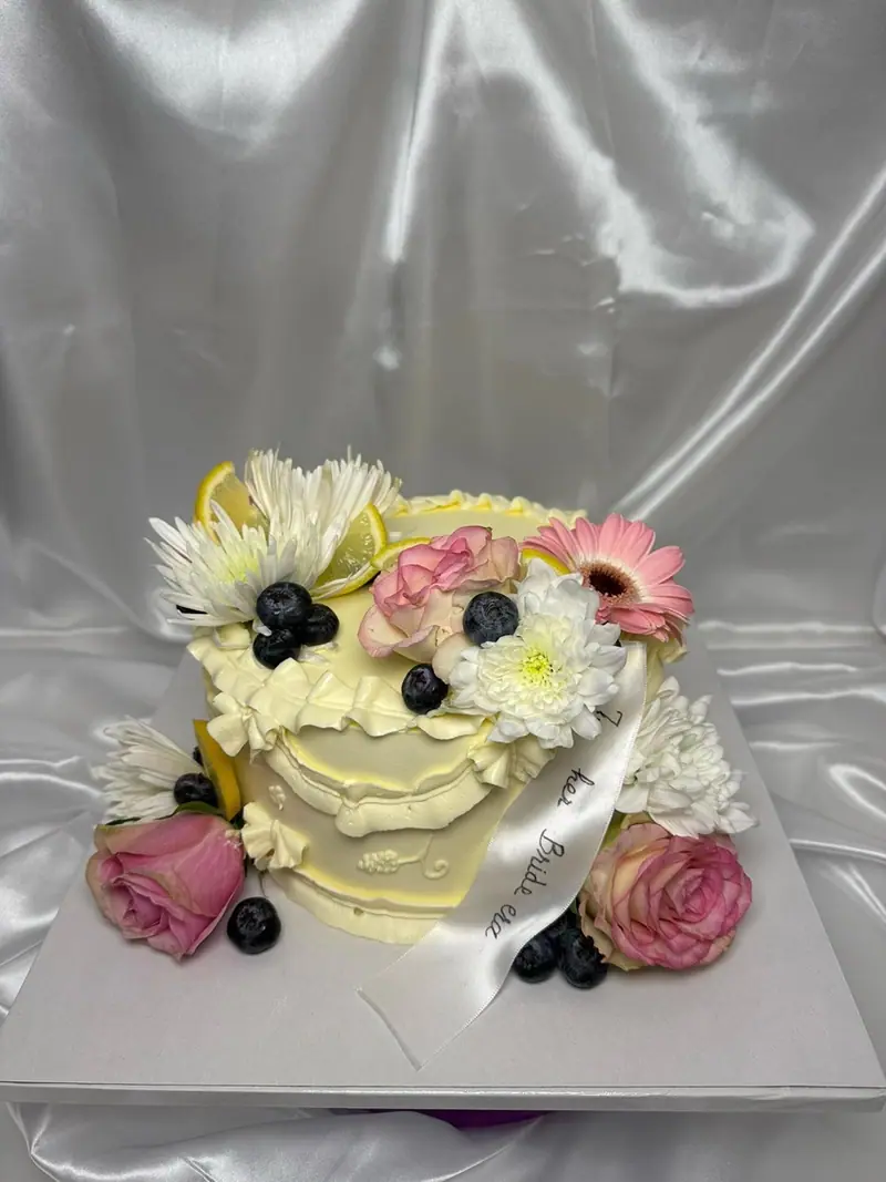 Bridal shower cake with fresh flowers and berries